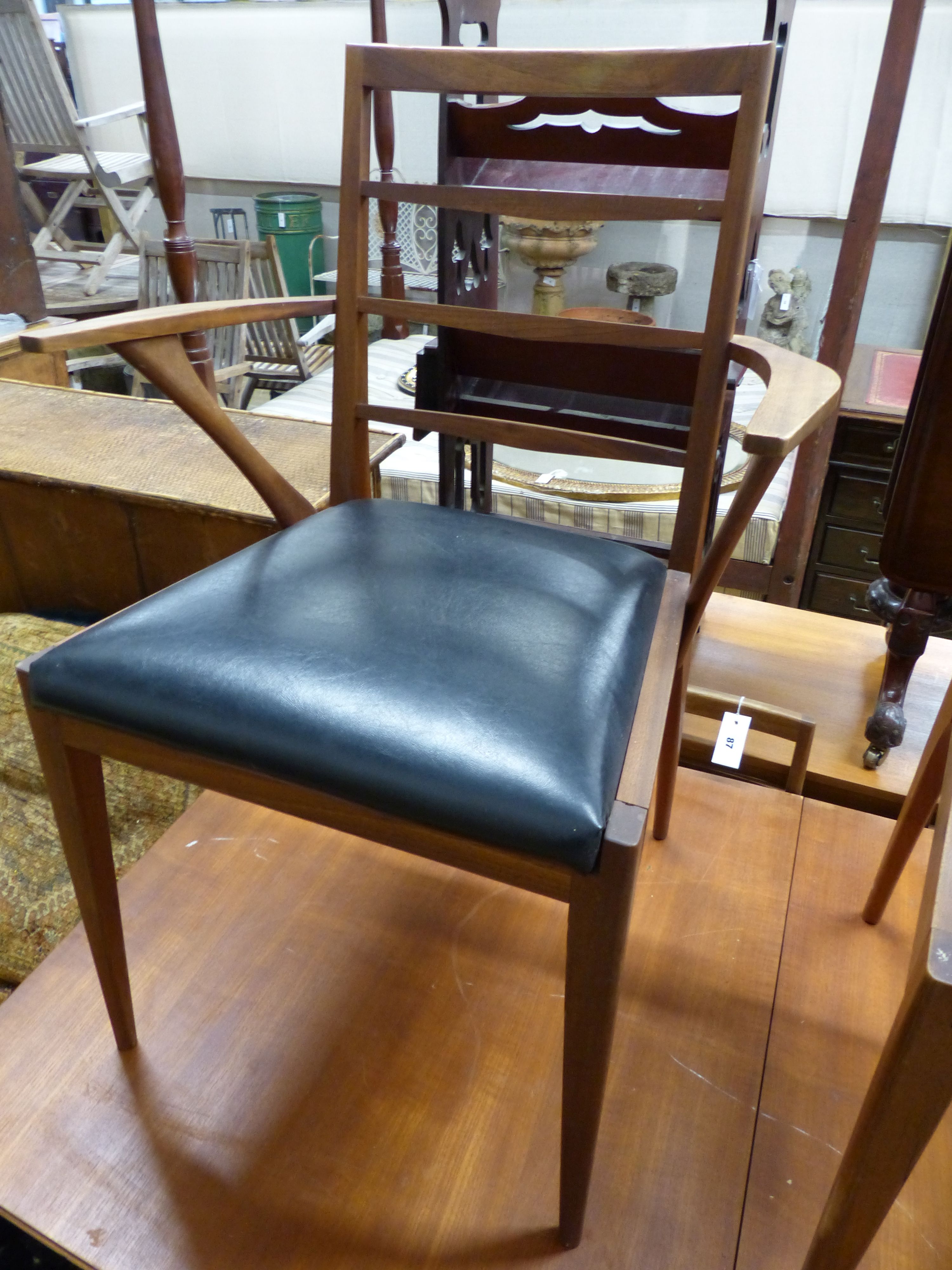 A mid century H McIntosh, extending teak dining suite comprising of table, six chairs and sideboard